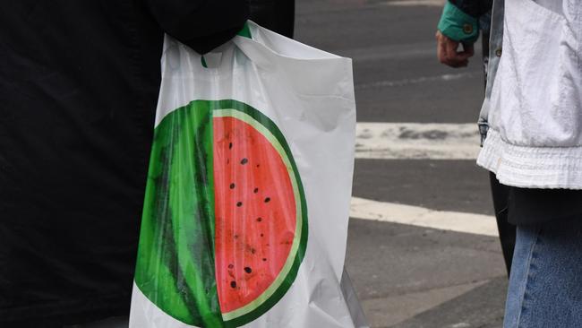 A shopper carries a reusable plastic bag at a Woolworths store. Picture: AAP Image/Peter Rae