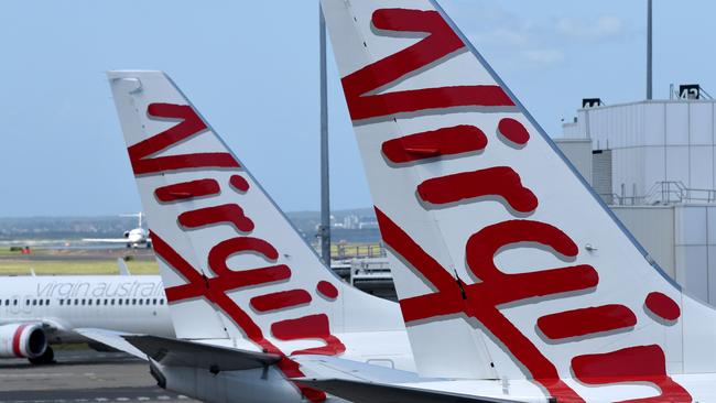 SYDNEY, AUSTRALIA - NCA NewsWire Photos FEBRUARY, 4, 2021: Virgin Australia aircraft are seen on the tarmac at Sydney Domestic Airport, Sydney. Virgin Australia says the end of JobKeeper in March could signal a mass shedding of workers if no further support is provided to the struggling aviation industry which has been out of action for almost one year. Picture: NCA NewsWire/Bianca De Marchi