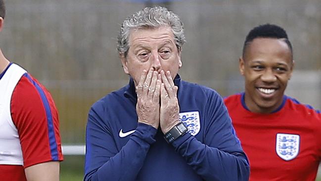 Roy Hodgson covers his face.