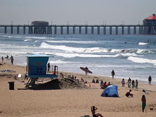 Judging by the scenes at Huntington Beach, California, you wouldn't know there was a pandemic going on. Picture: AFP