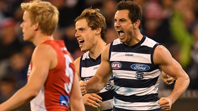 Daniel Menzel and Jake Kolodjashnij celebrate a Geelong goal.