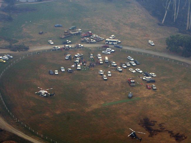 Locals gathered on the oval at Marysville in the fire’s aftermath. Picture: Mark Smith 