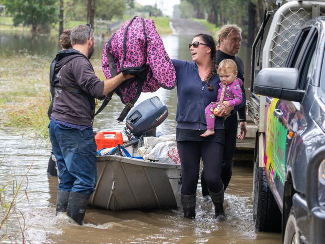 The floods have closed the roads into around Taree neighbours are using boats to cross roads and bring supplies to people trapped by the flood waters.Picture Thomas Lisson