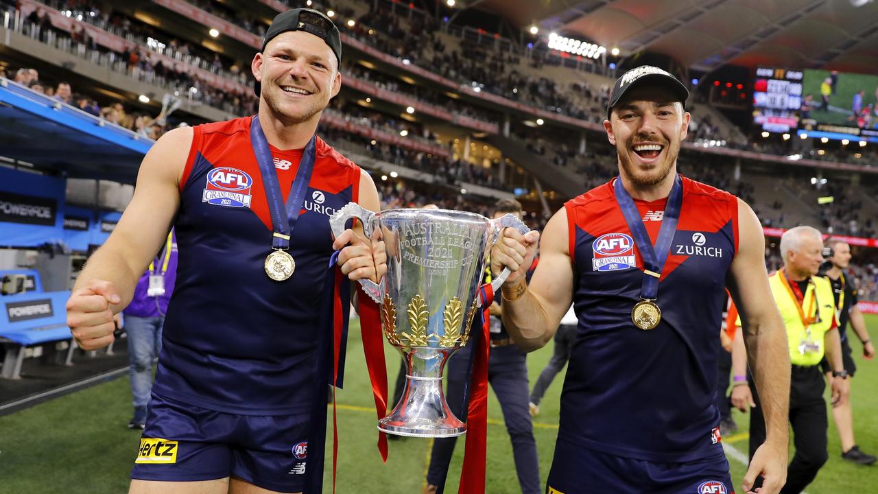 Steven May and Michael Hibberd celebrate with the premiership cup.