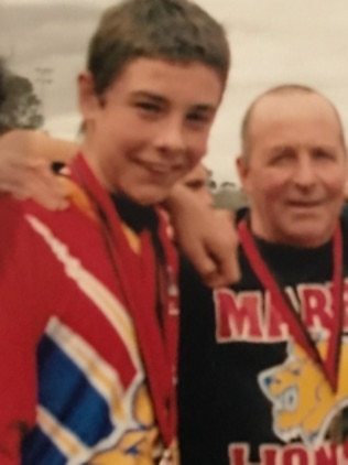 Rory Atkins with his dad Ken after Maribyrnong Park won the under 14 premiership. Picture: Supplied.