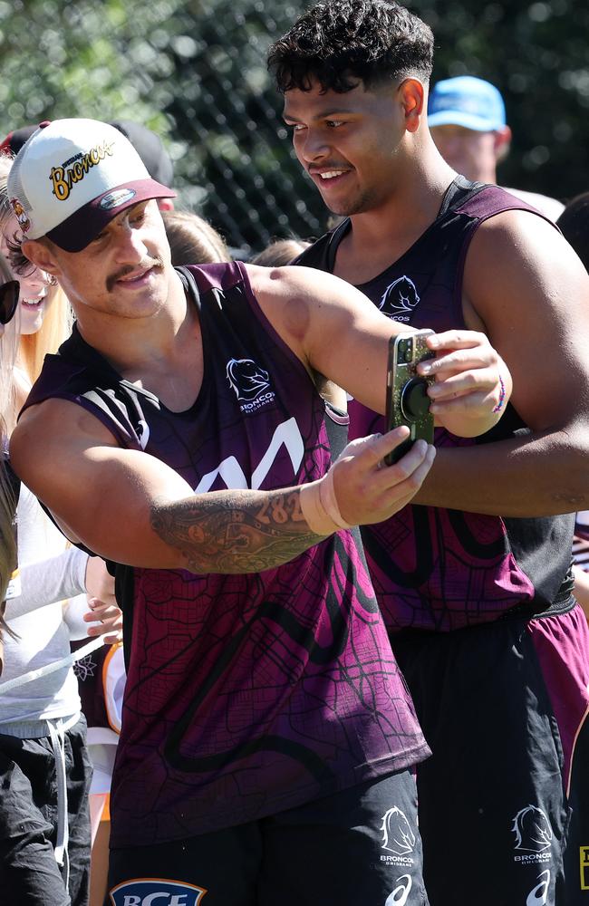 Fan favourites Kotoni Staggs and Selwyn Cobbo taking selfies with fans after Brisbane Broncos training at Red Hill. Picture: Liam Kidston