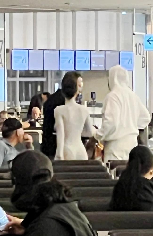 The couple were hard to miss and all eyes were on them as they made their way to their boarding gate. Picture: BACKGRID