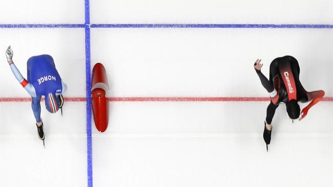 Try splitting Ted-Jan Bloemen of Canada, right, who crosses the finish line a fraction of a second before Norway's Sverre Lunde Pedersen. Picture: AP