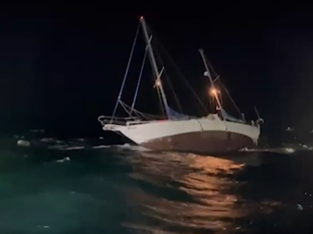 A father and son were rescued from their stricken yacht overnight after the vessel lodged on shallow rocks in rough seas. Picture: WA Police