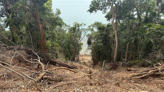 Landslides run for hundreds of metres down cliff faces and into the ocean on the Bloomfield Track between Wujal Wujal and Cape Tribulation.