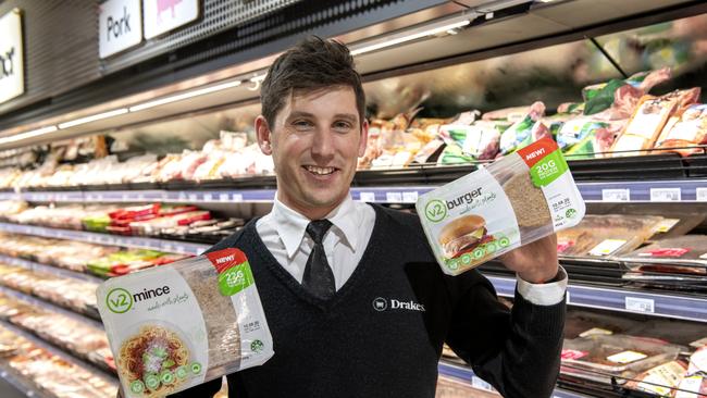 Drakes Supermarkets employee James McDowell with the v2food mince and burger packs. Picture: Supplied.