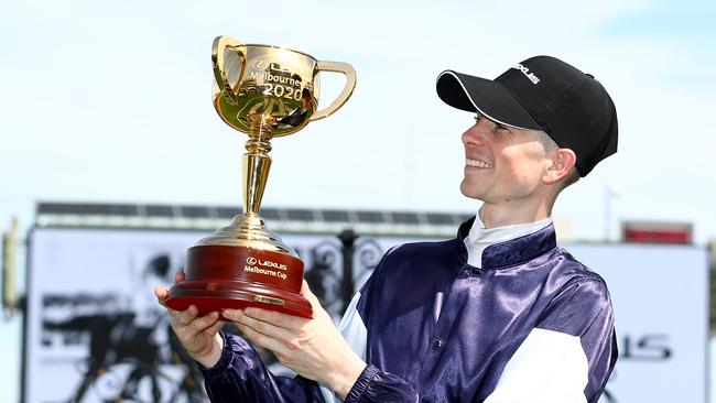 Jye McNeil poses with the 2020 Melbourne Cup after riding Twilight Payment to victory during 2020 Lexus Melbourne Cup Day. Picture: Robert Cianflone/Getty Images for the VRC