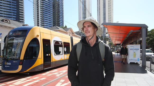 Josh Akehurst 27 from Broadbeach Waters gets off at the Light Rail station in Surfers Paradise.  Public transport usage has dropped 75 per cent with people fearing they can contract covid on the G. Picture Glenn Hampson