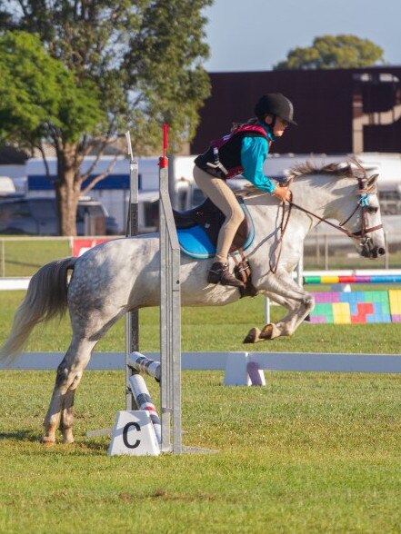 Abby Matsen and her pony Goodradigbee Snow Owl at the PQC State Showjumping Championships.