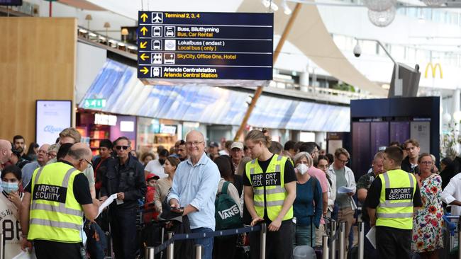 Passengers queue up at the booths of Scandinavian airline SAS in the departure hall at Arlanda airport, Stockholm, Sweden, on July 4. Picture: AFP