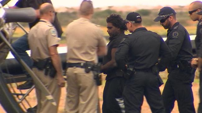 Murderer Dudley Davey is escorted away by police. Picture: Channel 7