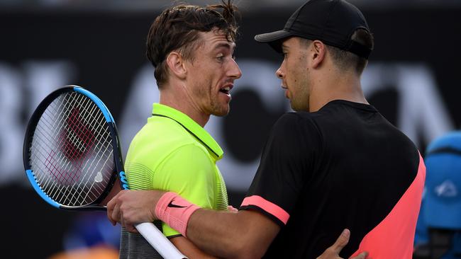 John Millman is congratulated on his win by Borna Coric.