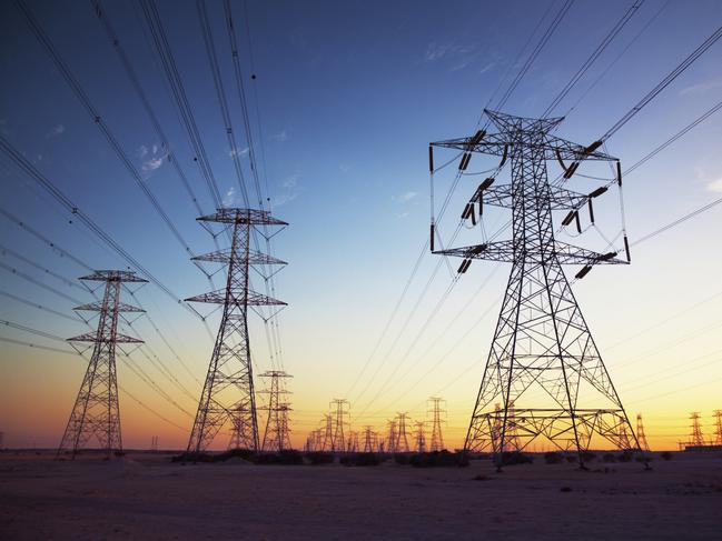 Power cables going in to the distance at dusk.