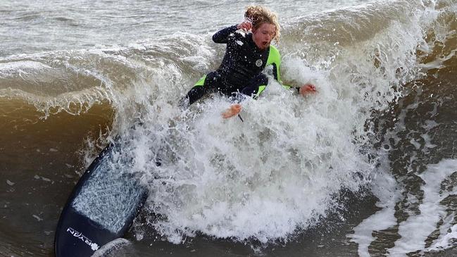 Surfers enjoying the unusual swell at Brighton Jetty. Picture: Rick Beal