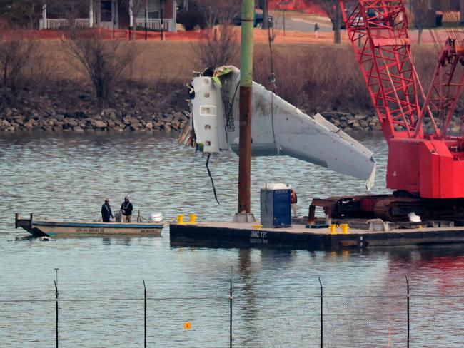 ARLINGTON, VIRGINIA - FEBRUARY 03: A wing of American Airlines flight 5342 is lifted from the Potomac River during recovery efforts on February 03, 2025 in Arlington, Virginia. An American Airlines flight from Wichita, Kansas collided midair with a military Black Hawk helicopter while on approach to Ronald Reagan Washington National Airport on January 29, 2025 outside of Washington, DC. According to reports, there were no survivors among the 67 people onboard both aircraft.   Chip Somodevilla/Getty Images/AFP (Photo by CHIP SOMODEVILLA / GETTY IMAGES NORTH AMERICA / Getty Images via AFP)