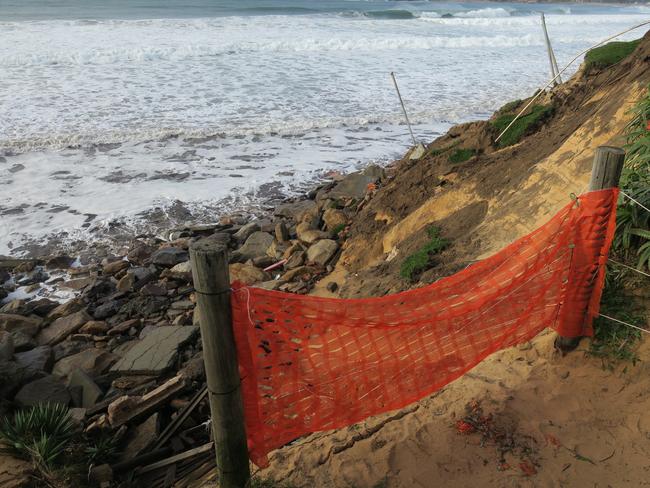 The public walkway has been fenced off after it collapsed into the sea. Picture: Richard Noone