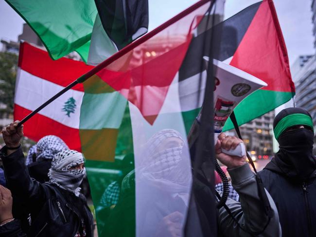 Demonstrators and pro-Palestinian group wave Lebanon's flags as they take part in a rally in support to Lebanon. Picture: AFP