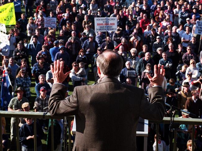 Aust Prime Minister John Howard having his back to the camera showing bulge of suspected bullet proof vest under his jacket while addressing anti-gun control law demonstration in Sale Vic.  body armor rally protective clothing  /Demonstrations/Australia