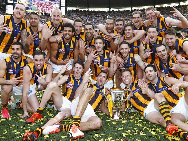 Hawthorn players celebrate a third straight flag. Picture: Michael Klein