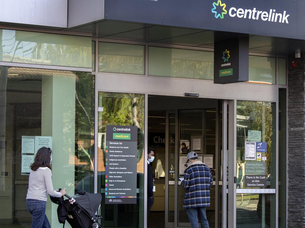 A customer talks to a staff member at Centrelink during stage 4 lockdowns in Melbourne. Picture: David Geraghty