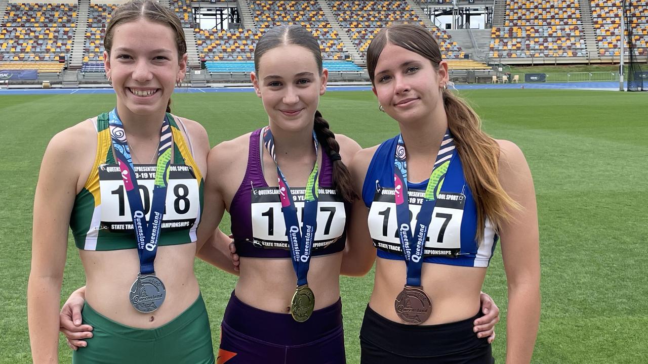 Taya Clayton, middle, broke a record at the Queensland Representative School Sport track and field championships on day four.