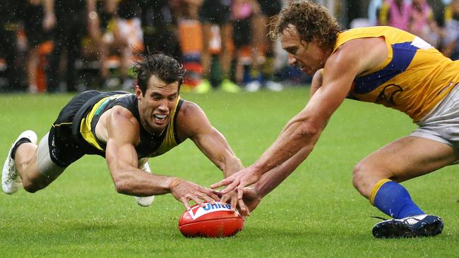 A desperate Alex Rance dives for a ground-level ball against West Coast star Matt Priddis. Picture: George Salpigtidis