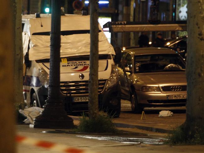 The car belonging to an attacker and a police van are pictured on the Champs Elysees in Paris.