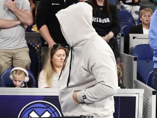 MELBOURNE, AUSTRALIA - NOVEMBER 17: A member of the crowd covers his face as he leaves the stadium during the round nine NBL match between Melbourne United and Adelaide 36ers at John Cain Arena, on November 17, 2024, in Melbourne, Australia. (Photo by Darrian Traynor/Getty Images)