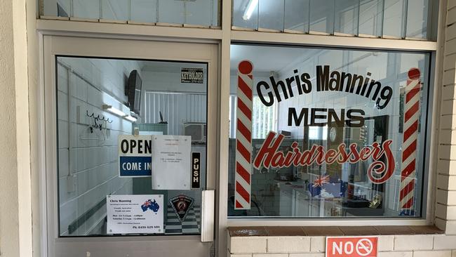 A sign at a Nerang barber explaining shortened trading hours were because of the China virus.