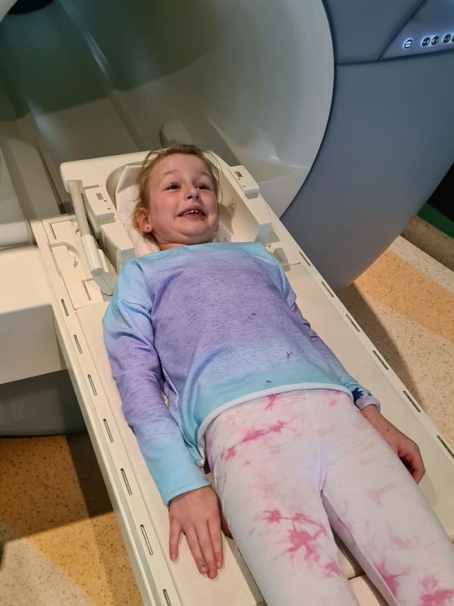 Brave Lucy heading into the MRI machine for a scan.