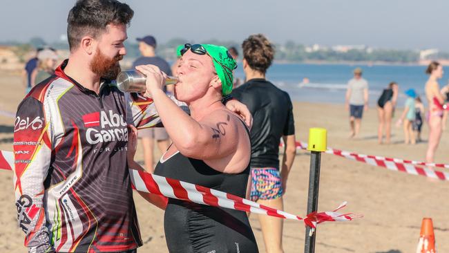 Meaghan Jones earns a long awaited beer from husband Johnno of the 1.2 K of the McArthur River Mining Darwin Ocean Swim at Casuarina Beach. Picture: Glenn Campbell