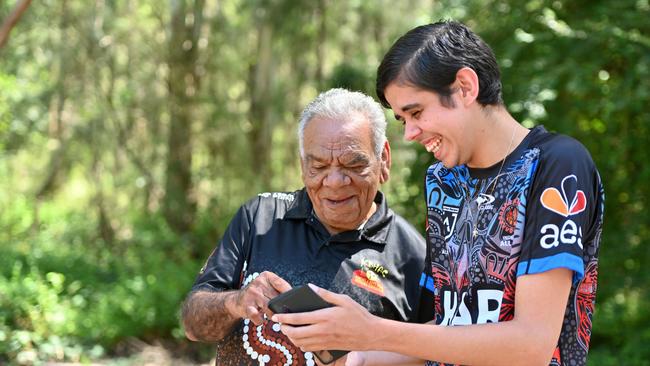 Stolen generation survivor Uncle Stephen Ridgeway SNR with his great nephew Wade being shown the 13YARN social media pages and website. Source: Supplied