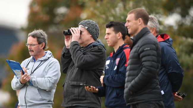 Melbourne Demons recruiters and head coach Simon Goodwin (right) watch on during the draft combine in 2019.