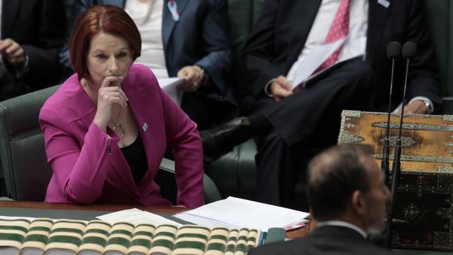 Then-PM Julia Gillard listens as then-Opposition leader Tony Abbott addresses the Parliament in November 2012. Picture: Ray Strange