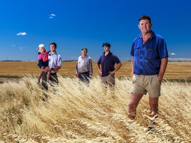 27/11/2023 Farmer Chris Johns (right) pictured with his family (L-R) Mitch, holding his daughter Evie (4), dad Max (86) and Lachie on their property in Dooen near Horsham in western Victoria. Aaron Francis / The Australian