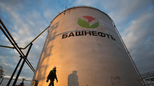 An employee passes a storage tank at an oil delivery point operated by Bashneft PAO in Russia. Picture: Bloomberg