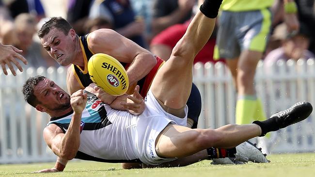 Brad Crouch tackles Port Adelaide’s Travis Boak.