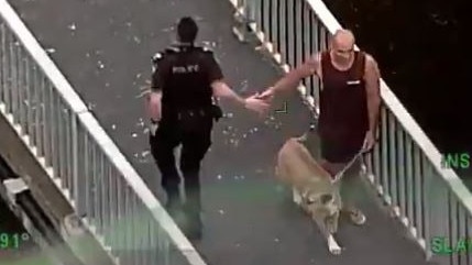 A police officer thanks the member of the public who tackled Sen for his assistance. Photo: Queensland Police