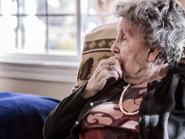 DEMENTIA CARE: In-home design, including better lighting and using contrasting colours, are keys to managing patient needs.Portrait of an elderly woman sitting alone in a senior care facility