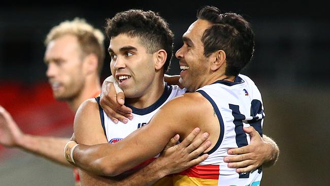 GOLD COAST, AUSTRALIA - JULY 13: Tyson Stengle of the Crows celebrates his goal with team mate Eddie Betts during the round 17 AFL match between the Gold Coast Suns and the Adelaide Crows at Metricon Stadium on July 13, 2019 in Gold Coast, Australia. (Photo by Jono Searle/AFL Photos via Getty Images)