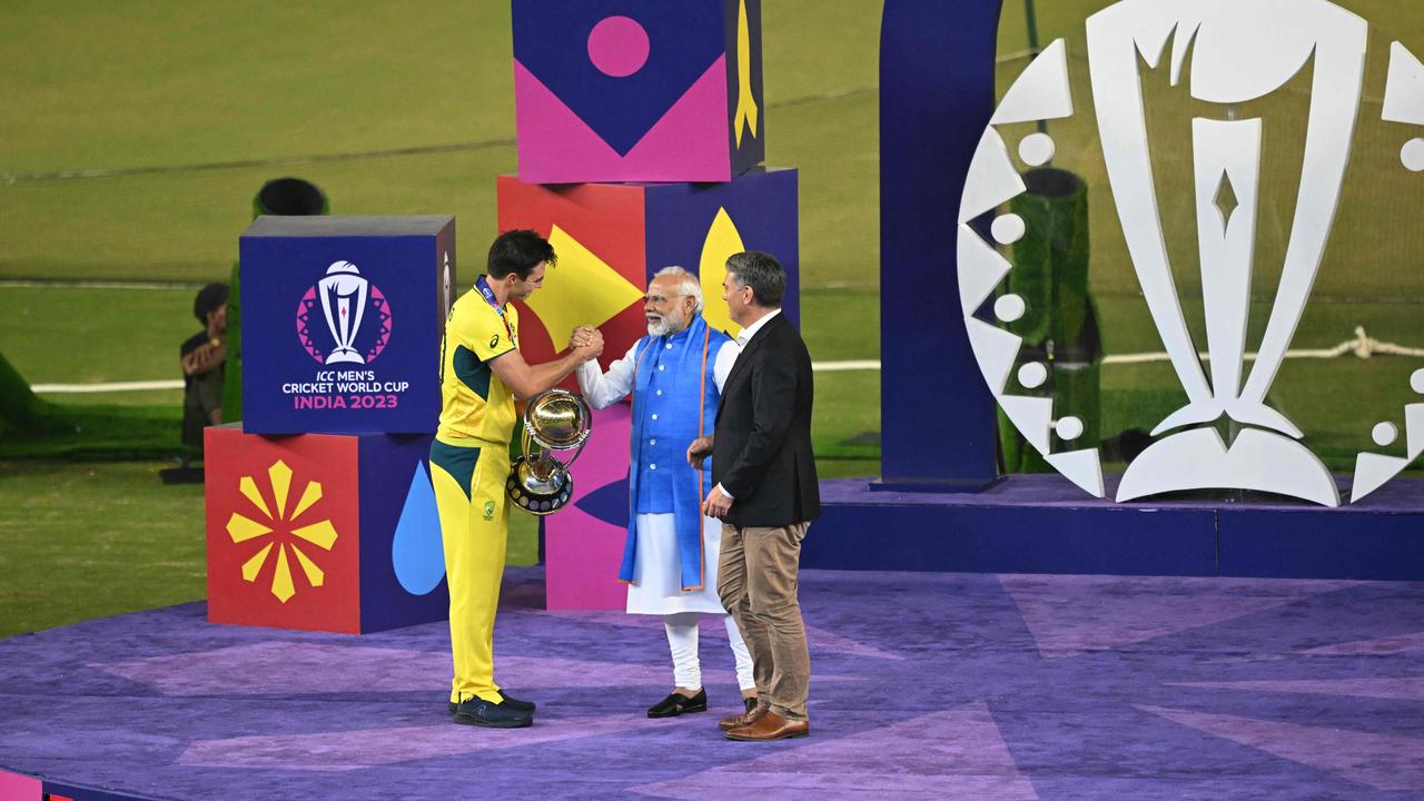 Australia's captain Pat Cummins receives the ICC Cricket World Cup Trophy. Photo by Money SHARMA / AFP.