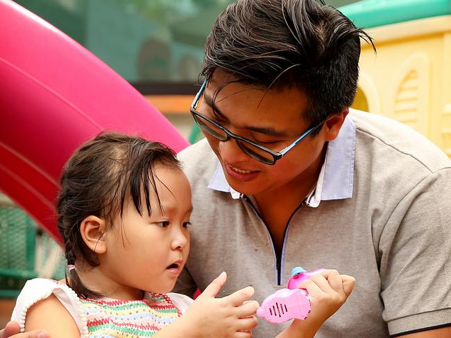 Annabelle Nguyen with her father Henry play in the small playground at the Clinica 0-19 in Monterrey Mexico. Picture: Nathan Edwards