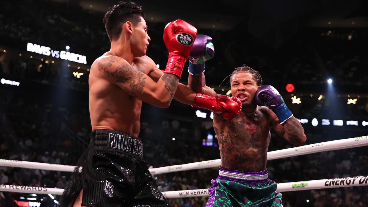 Ryan Garcia in the black trunks exchanges punches with Gervonta Davis in the green. Photo by Al Bello/Getty Images.