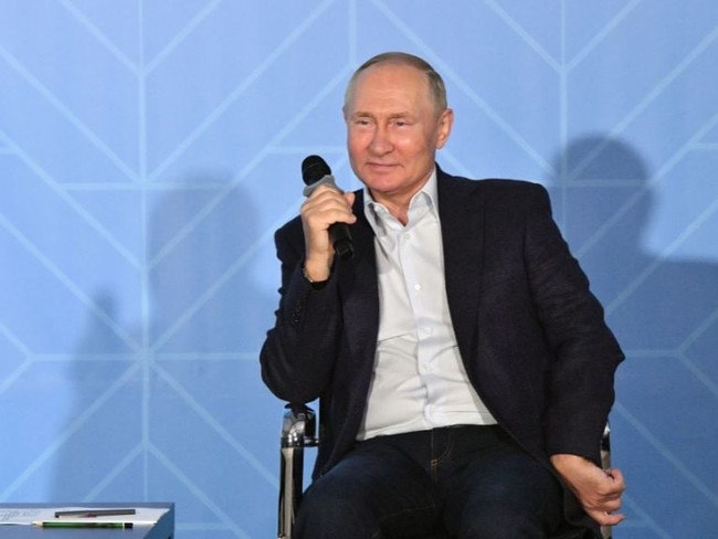 Putin appeared flushed as he clutched his seat. Picture: EPA/AAP