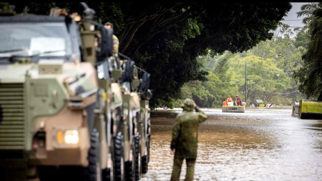 Australian Army soldiers in Bushmaster protected mobility vehicles are on standby to conduct evacuation tasks with the local State Emergency Services (SES) due to rising flood waters. (Photo by Jonathan GEODHART / AUSTRALIA DEFENCE FORCE)